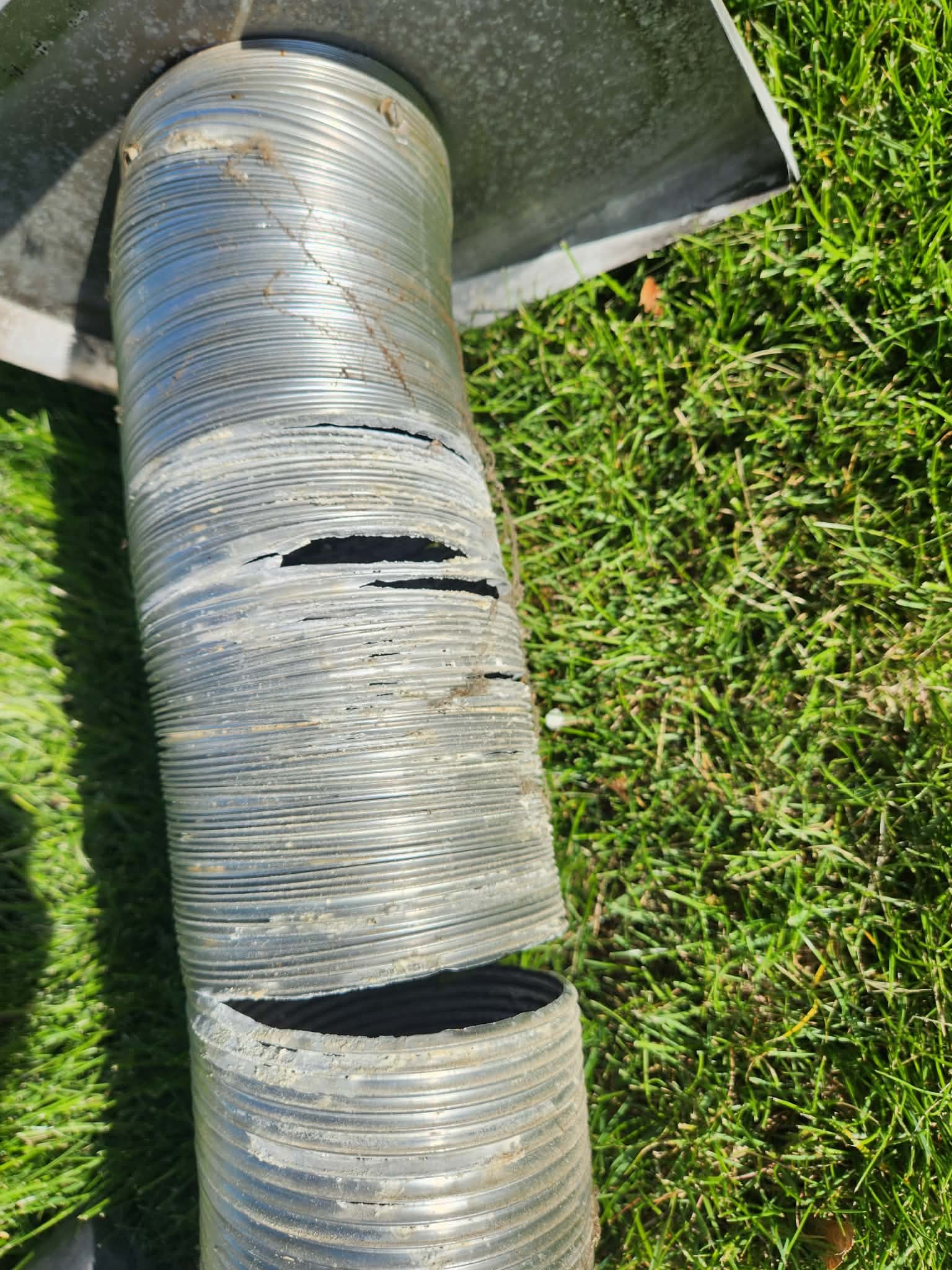 Severe damage and tearing on a metal chimney flue liner